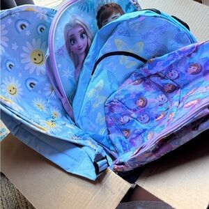 Box of 4 backpacks. Two are Frozen themed.